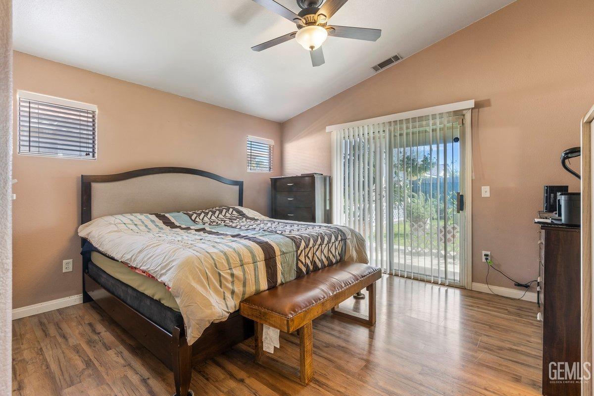 Undisclosed Address Bakersfield, CA 93312 - Photo 11 of 31 a bedroom with a large bed and a chandelier