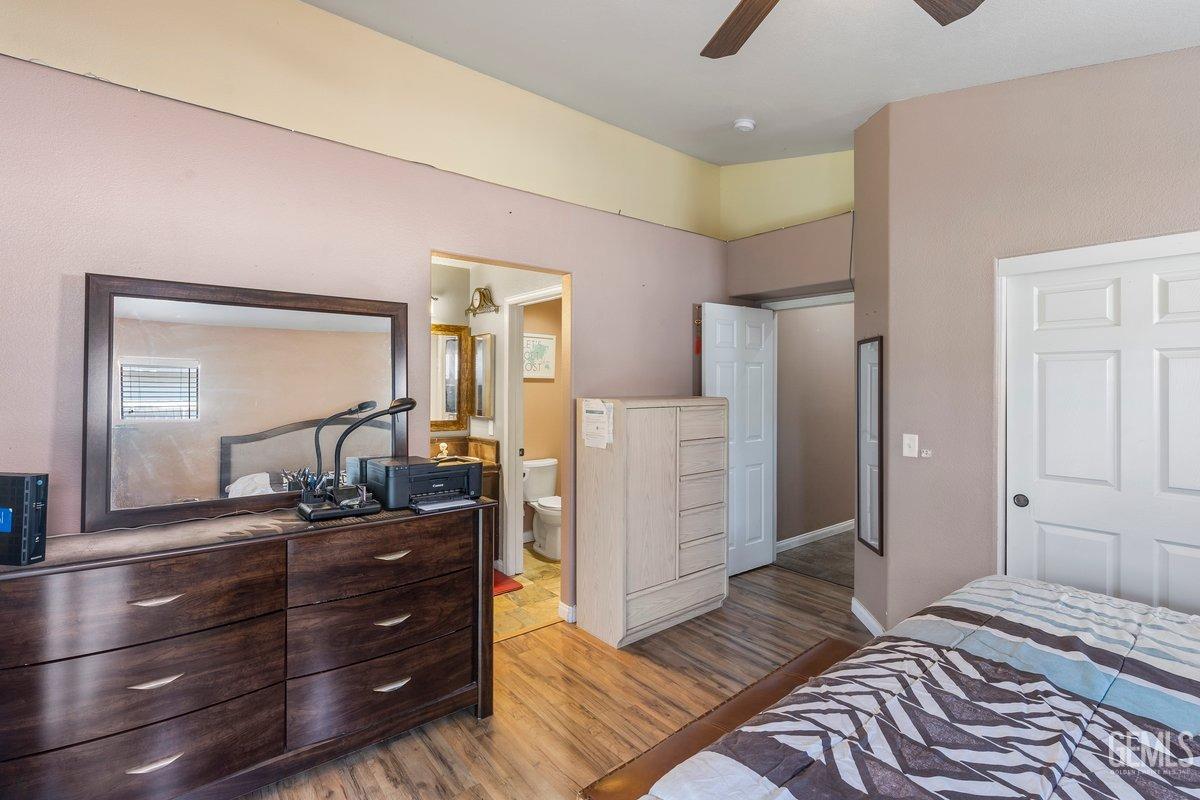 Undisclosed Address Bakersfield, CA 93312 - Photo 12 of 31 a bedroom with a bed and a dresser