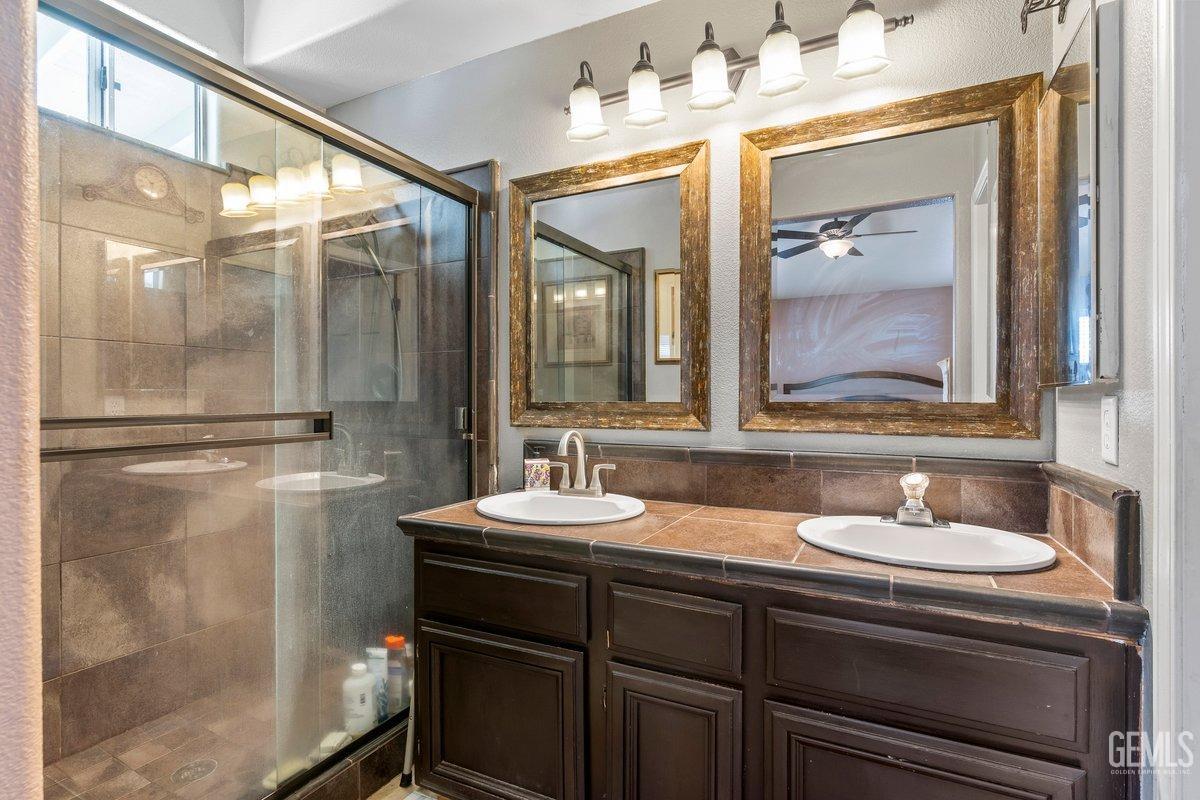 Undisclosed Address Bakersfield, CA 93312 - Photo 13 of 31 a bathroom with a sink and a mirror