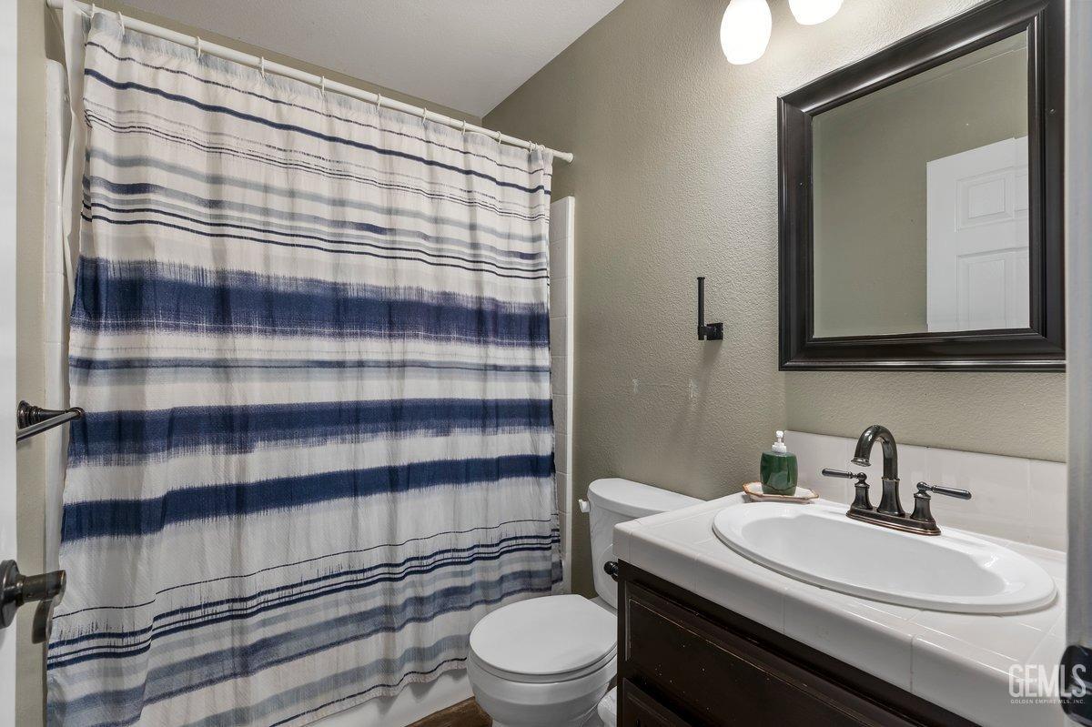 Undisclosed Address Bakersfield, CA 93312 - Photo 16 of 31 a bathroom with a sink a toilet and shower