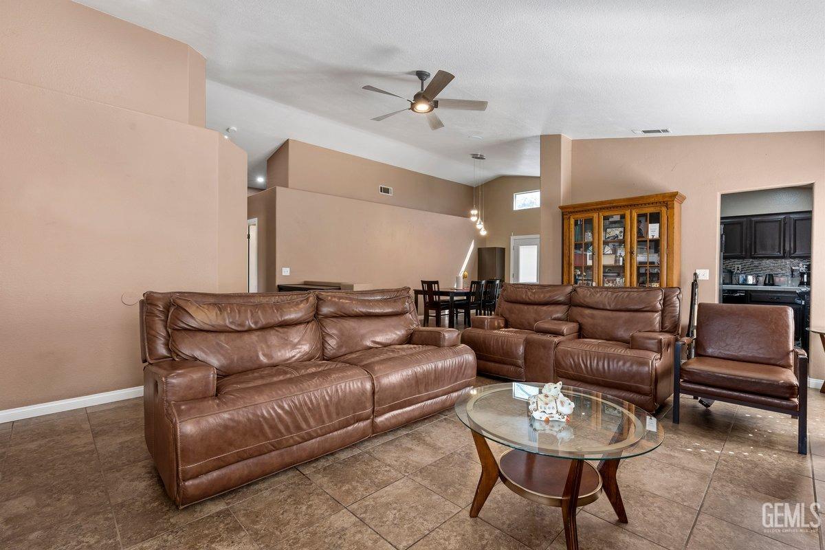 Undisclosed Address Bakersfield, CA 93312 - Photo 20 of 31 a living room with furniture and a flat screen tv