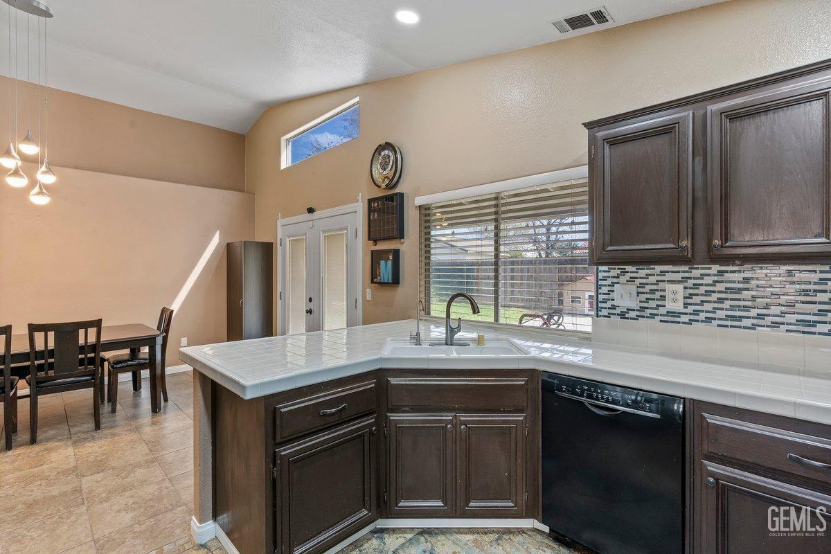 Undisclosed Address Bakersfield, CA 93312 - Photo 25 of 31 a kitchen with stainless steel appliances granite countertop a sink stove and cabinets