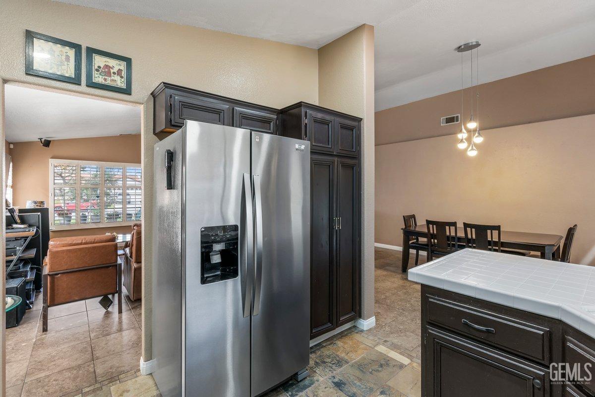 Undisclosed Address Bakersfield, CA 93312 - Photo 26 of 31 a kitchen with a refrigerator and a stove