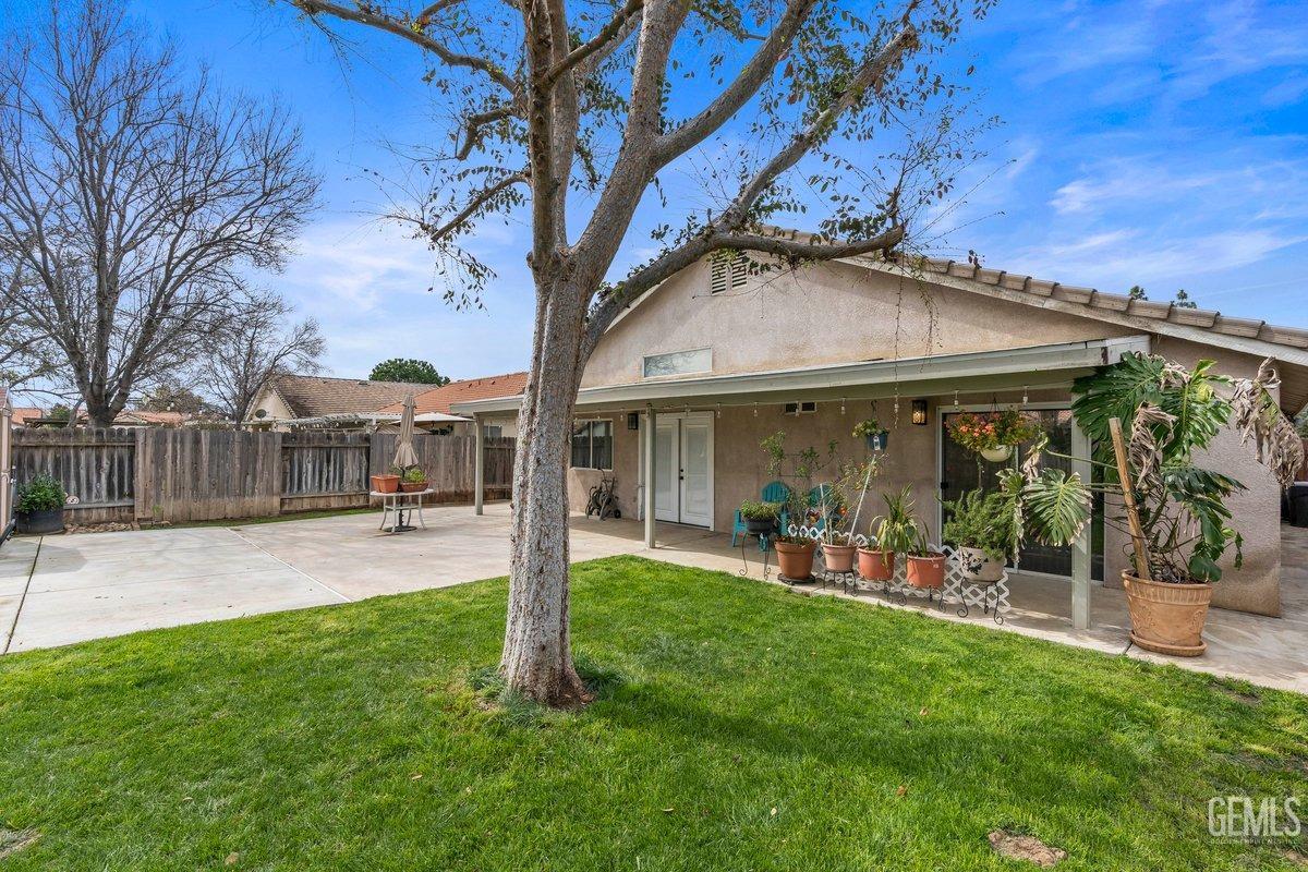Undisclosed Address Bakersfield, CA 93312 - Photo 29 of 31 a patio with a table and chairs and potted plants