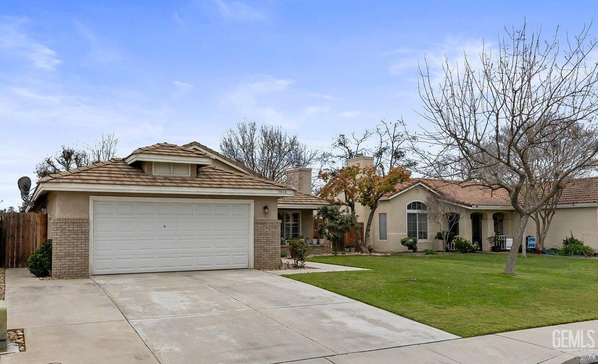 Undisclosed Address Bakersfield, CA 93312 - Photo 3 of 31 a front view of a house with a yard
