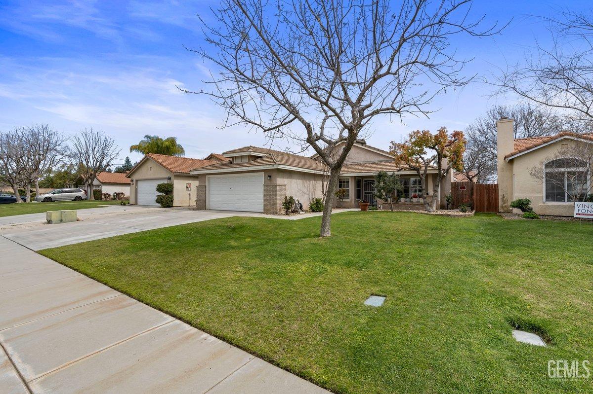Undisclosed Address Bakersfield, CA 93312 - Photo 4 of 31 a front view of house with yard and green space