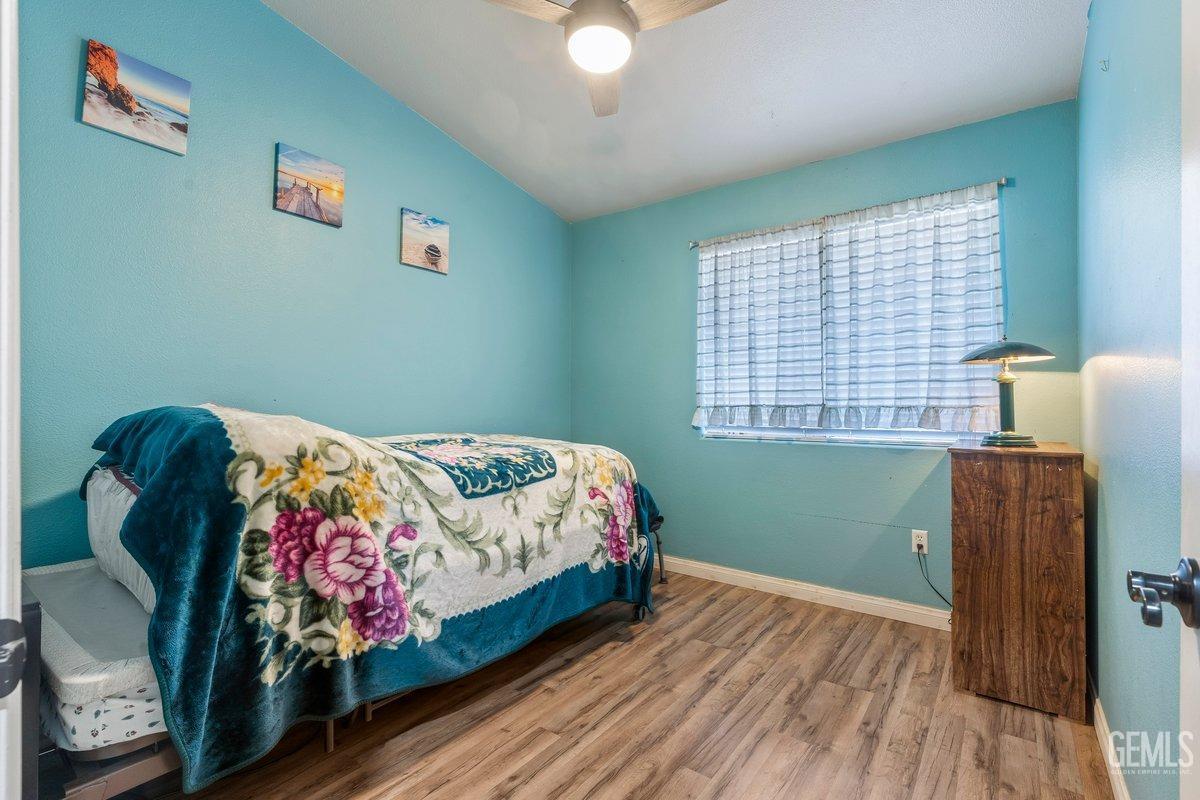 Undisclosed Address Bakersfield, CA 93312 - Photo 8 of 31 a bedroom with a bed and a window