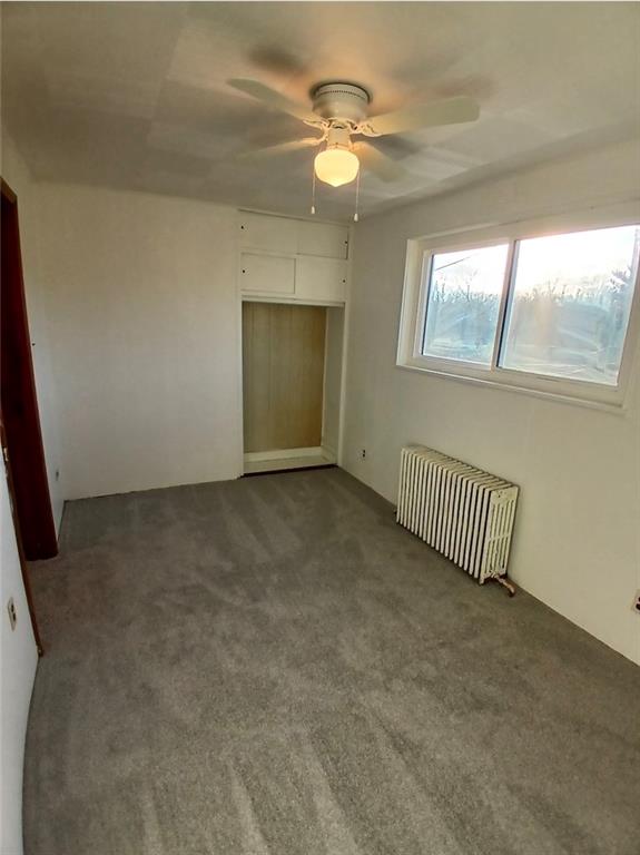 231 Rinne Street Pittsburgh, PA 15210 - Photo 13 of 24 en empty room with windows and ceiling fan
