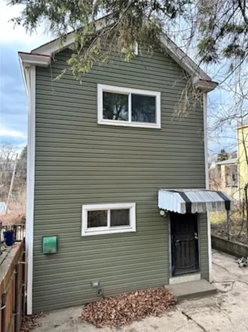 a brick house with a small table and chairs