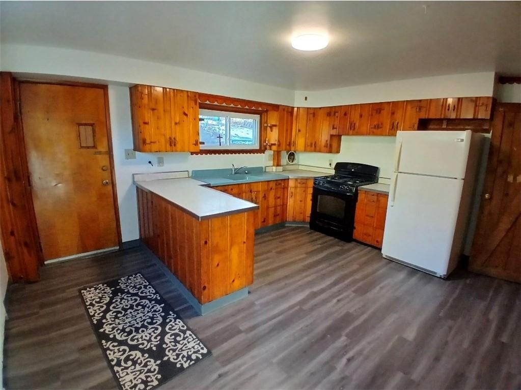 231 Rinne Street Pittsburgh, PA 15210 - Photo 5 of 24 a kitchen with a refrigerator and a stove top oven