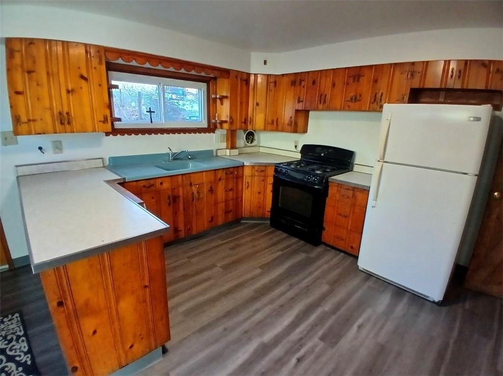 231 Rinne Street Pittsburgh, PA 15210 - Photo 6 of 24 a kitchen with stainless steel appliances a refrigerator and a stove top oven