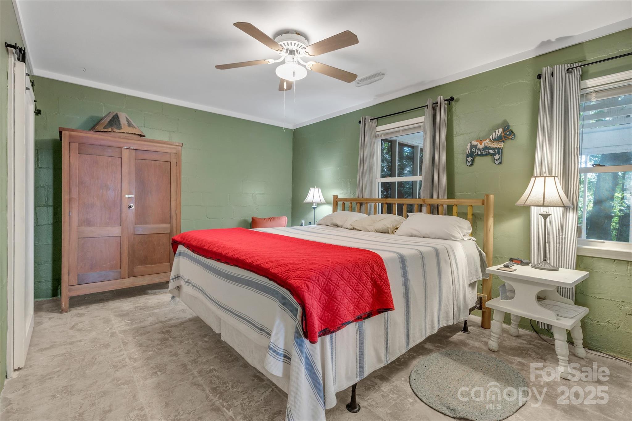 3605 Skyuka Mountain Road Columbus, NC 28722 - Photo 12 of 46 a spacious bedroom with a bed and a chandelier