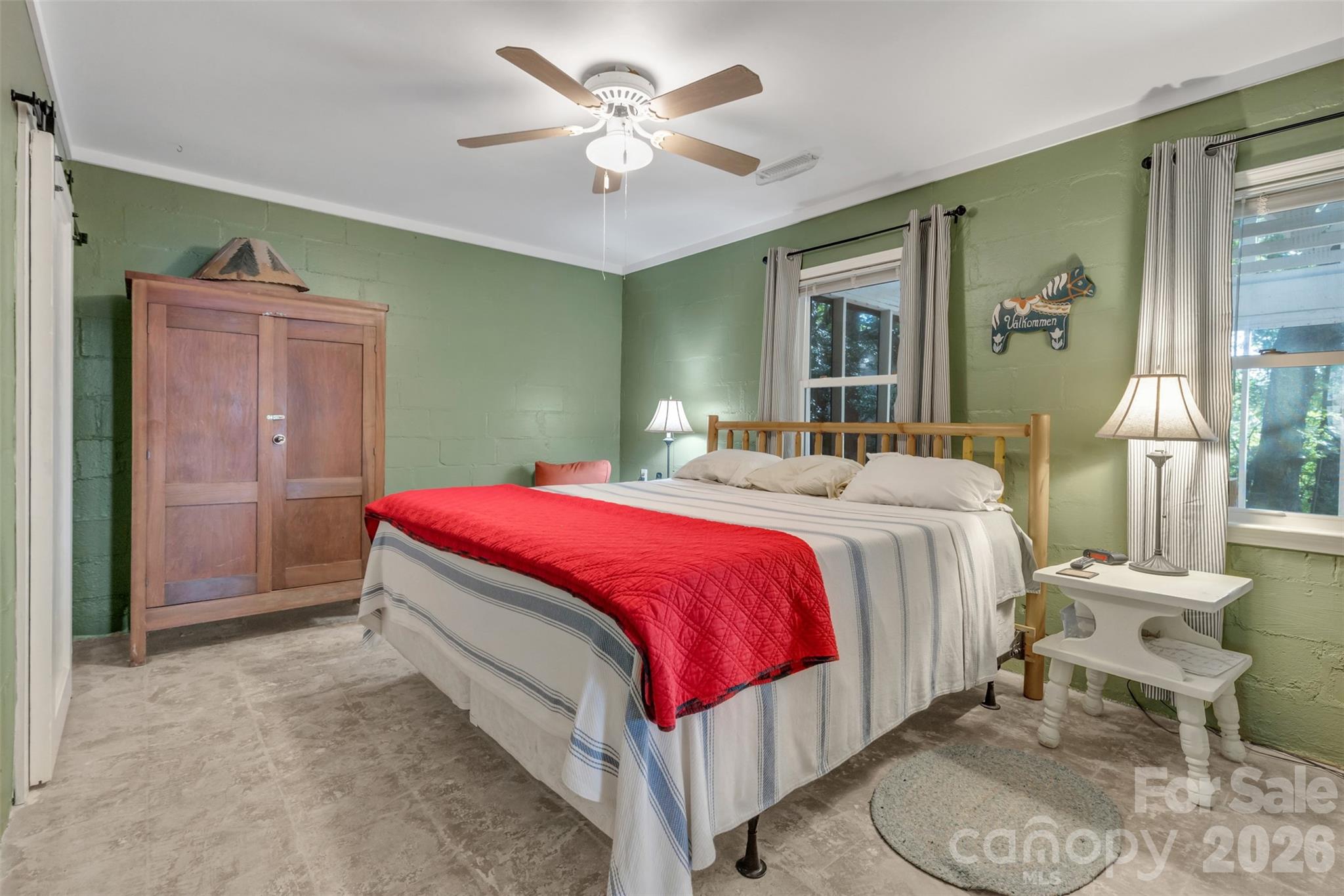 3605 Skyuka Mountain Road Columbus, NC 28722 - Photo 14 of 48 a spacious bedroom with a bed and a chandelier