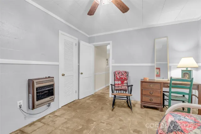 a living room with furniture a flat screen tv and a chandelier