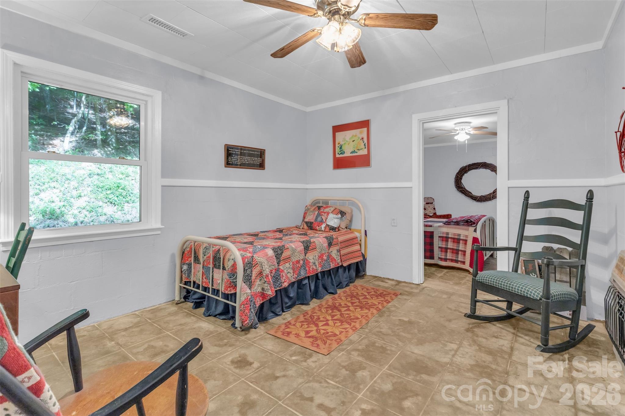 3605 Skyuka Mountain Road Columbus, NC 28722 - Photo 19 of 48 a bedroom with a bed and a chandelier