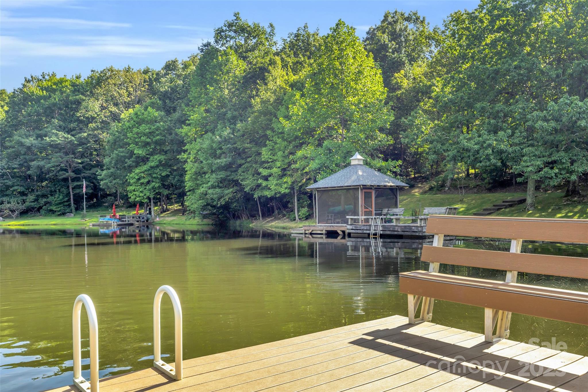 3605 Skyuka Mountain Road Columbus, NC 28722 - Photo 32 of 46 a view of a lake with house next to a yard