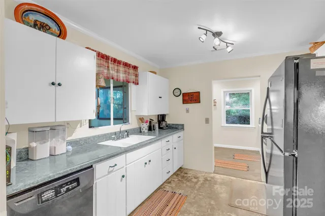 a bathroom with a granite countertop sink a mirror and a shower