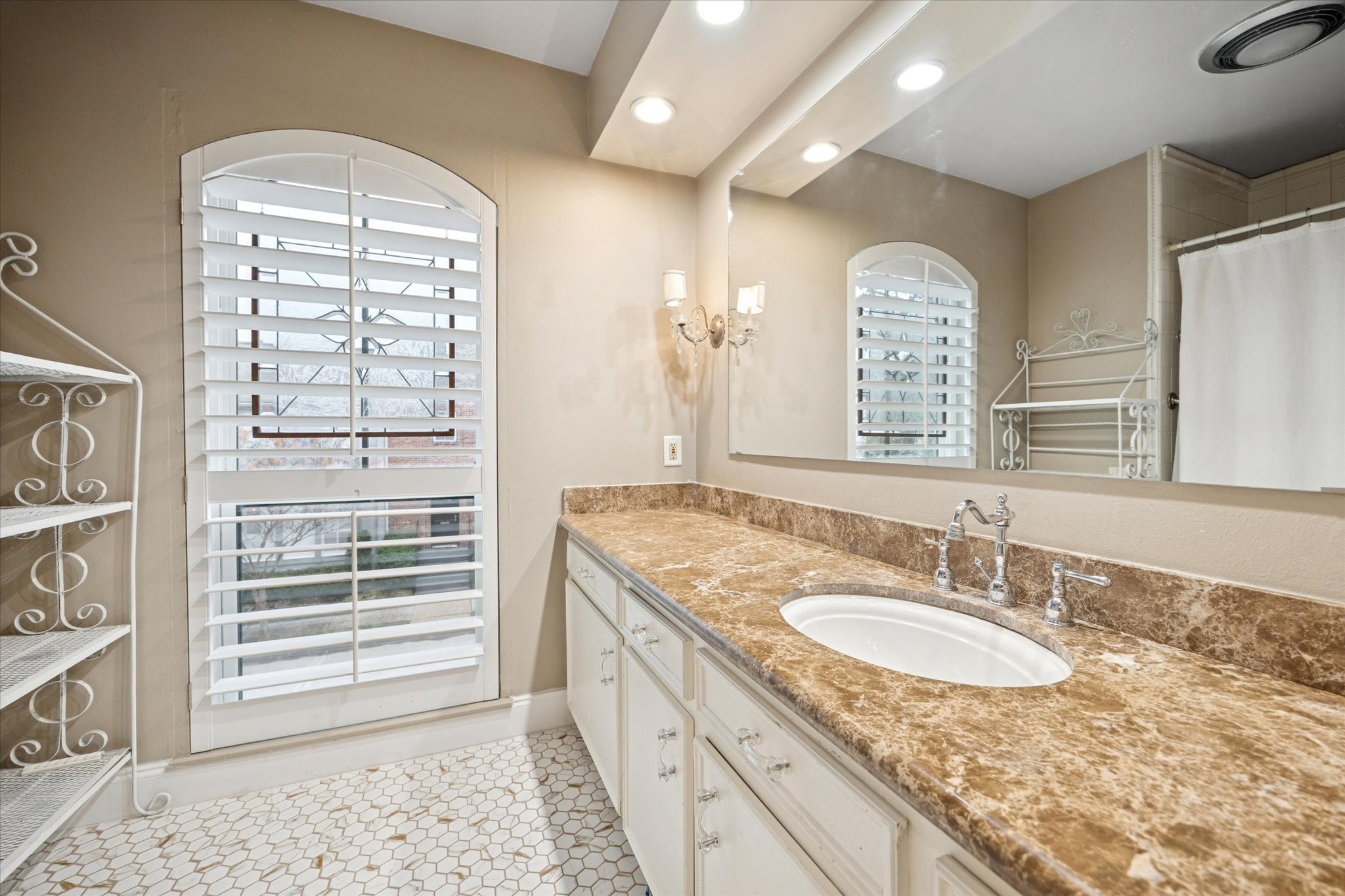 7525 Del Monte Drive Houston, TX 77063 - Photo 22 of 30 a bathroom with a granite countertop sink a mirror and a shower