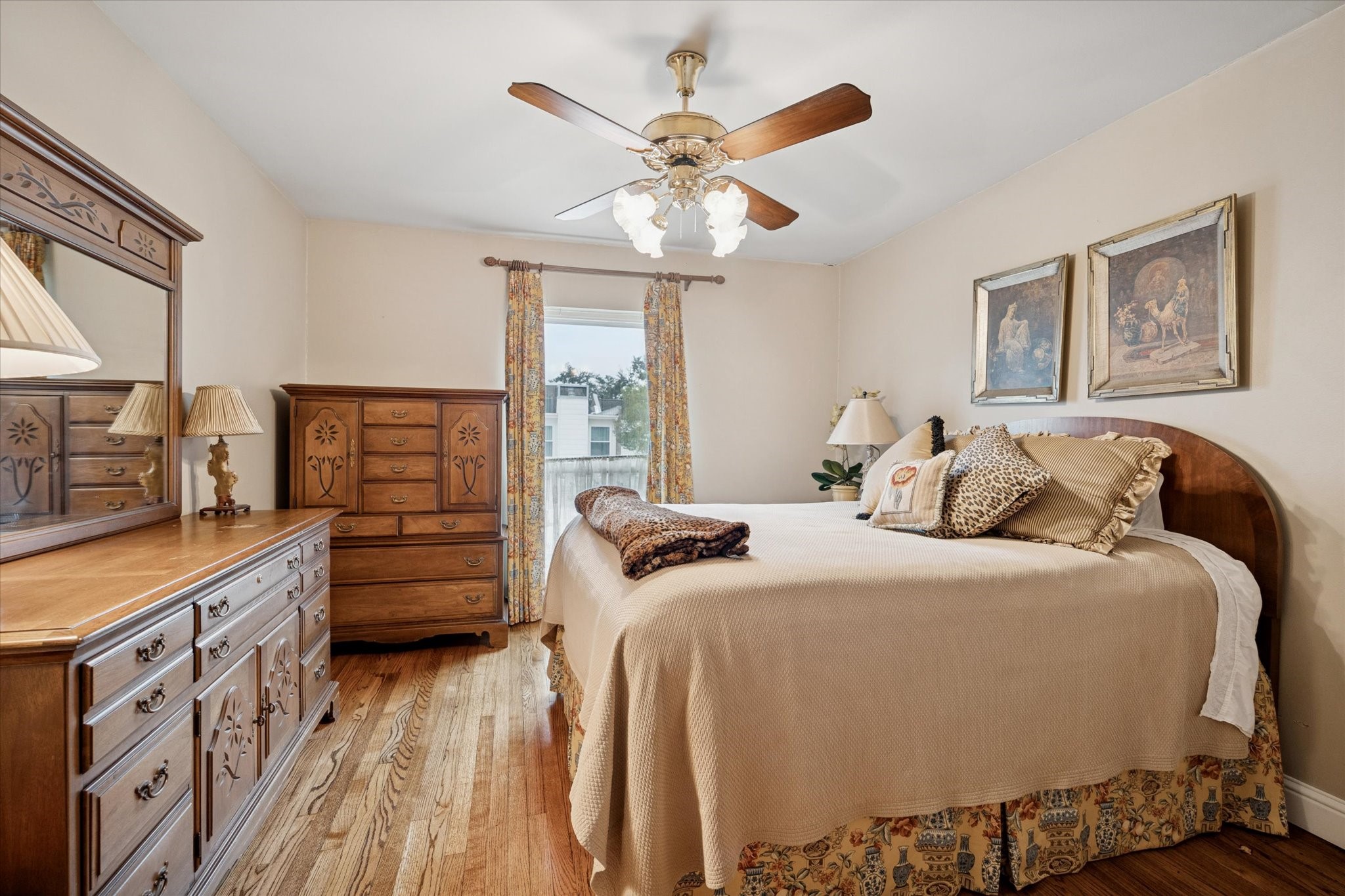 7525 Del Monte Drive Houston, TX 77063 - Photo 23 of 30 a bedroom with a bed and a chandelier