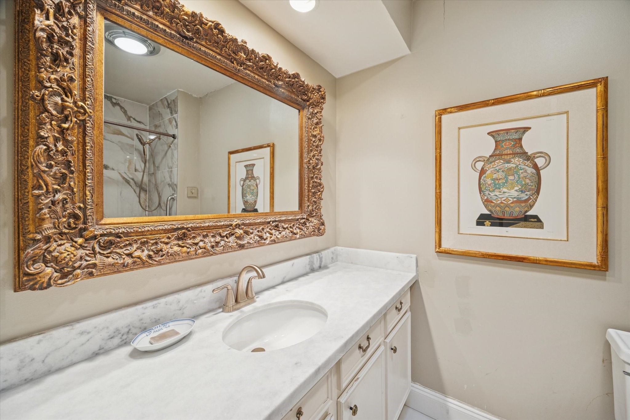 7525 Del Monte Drive Houston, TX 77063 - Photo 24 of 30 a bathroom with a granite countertop sink and a mirror