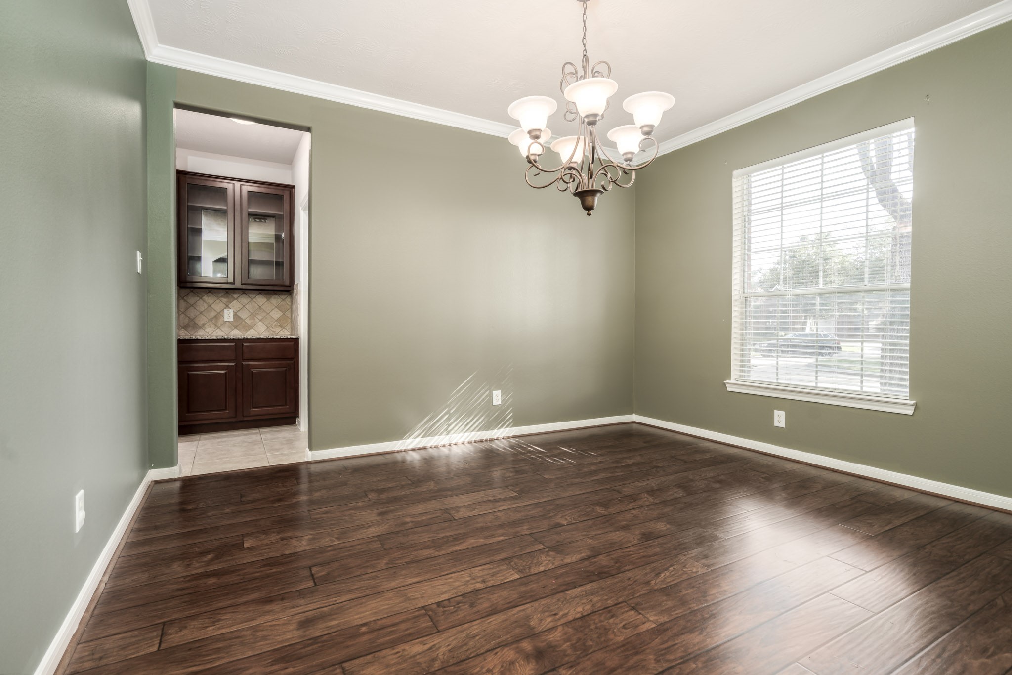 6518 Montana Ridge Court Houston, TX 77041 - Photo 9 of 27 a view of an empty room with wooden floor and a window
