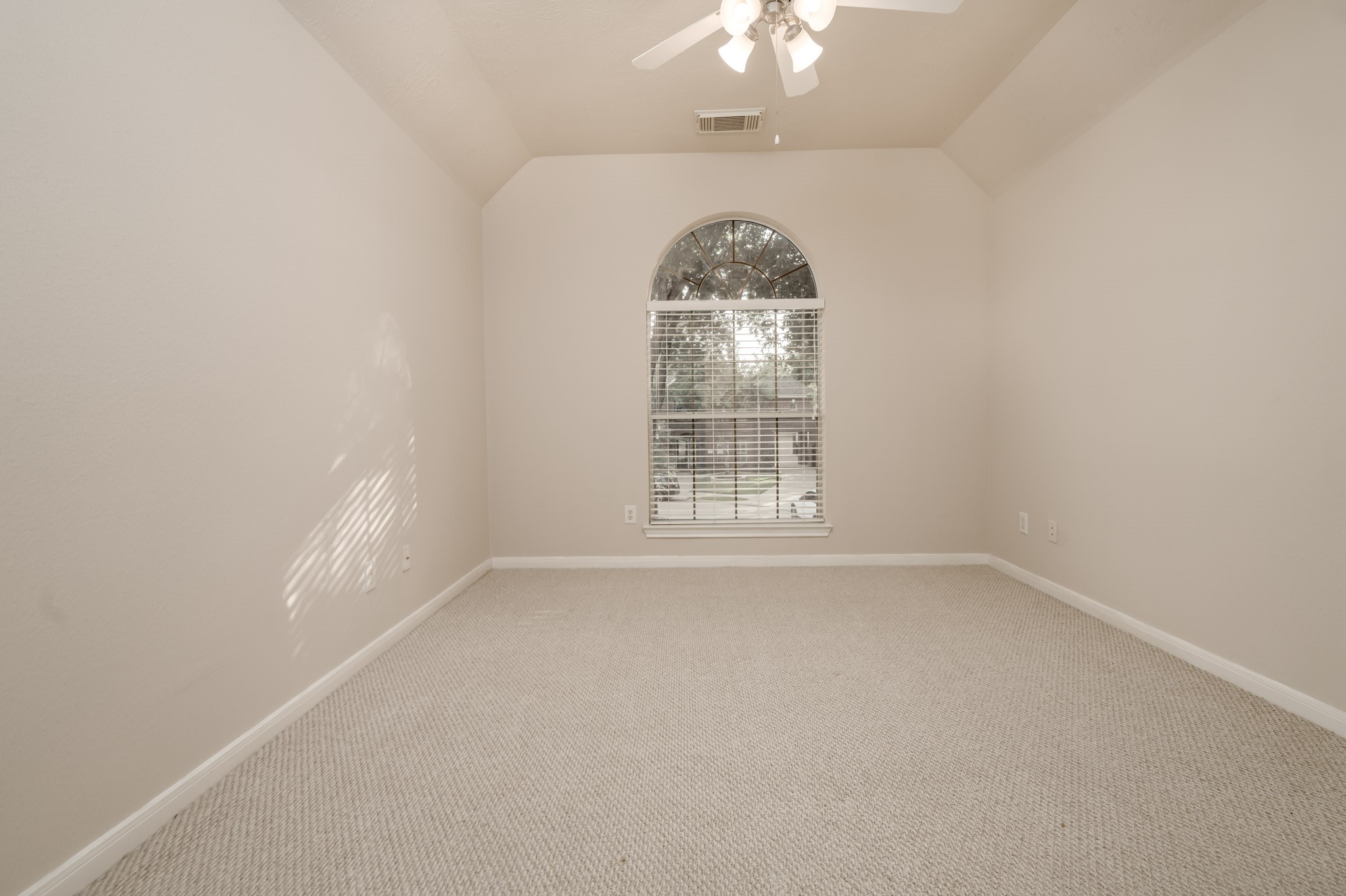 6518 Montana Ridge Court Houston, TX 77041 - Photo 10 of 27 an empty room with a chandelier fan and windows