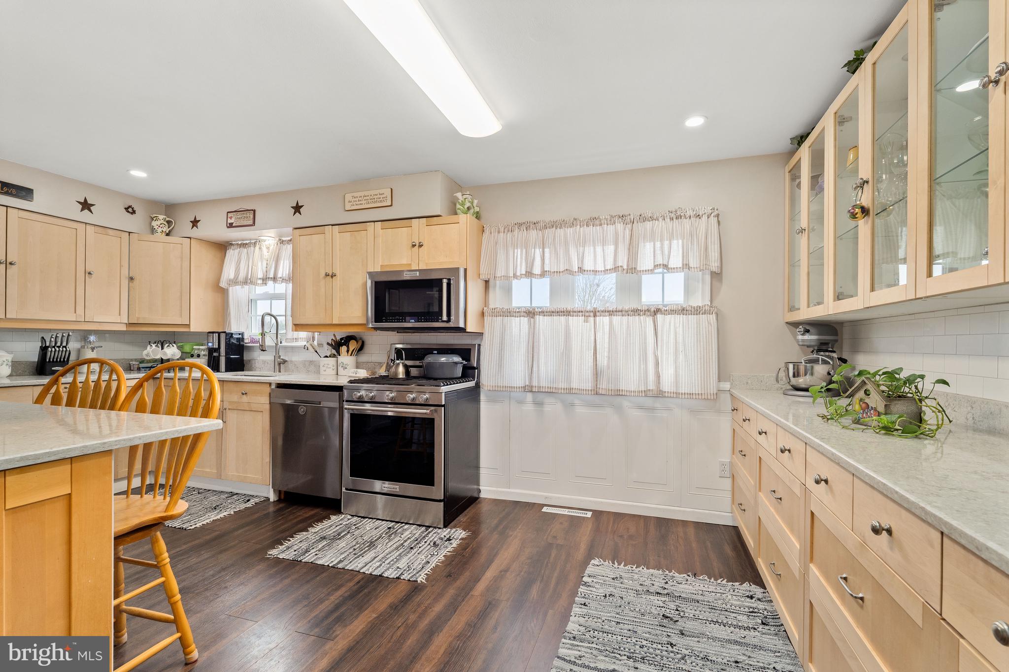 26 Southbridge Road Bear, DE 19701 - Photo 18 of 29 a kitchen with granite countertop a stove top oven a sink dishwasher and a refrigerator with wooden floor