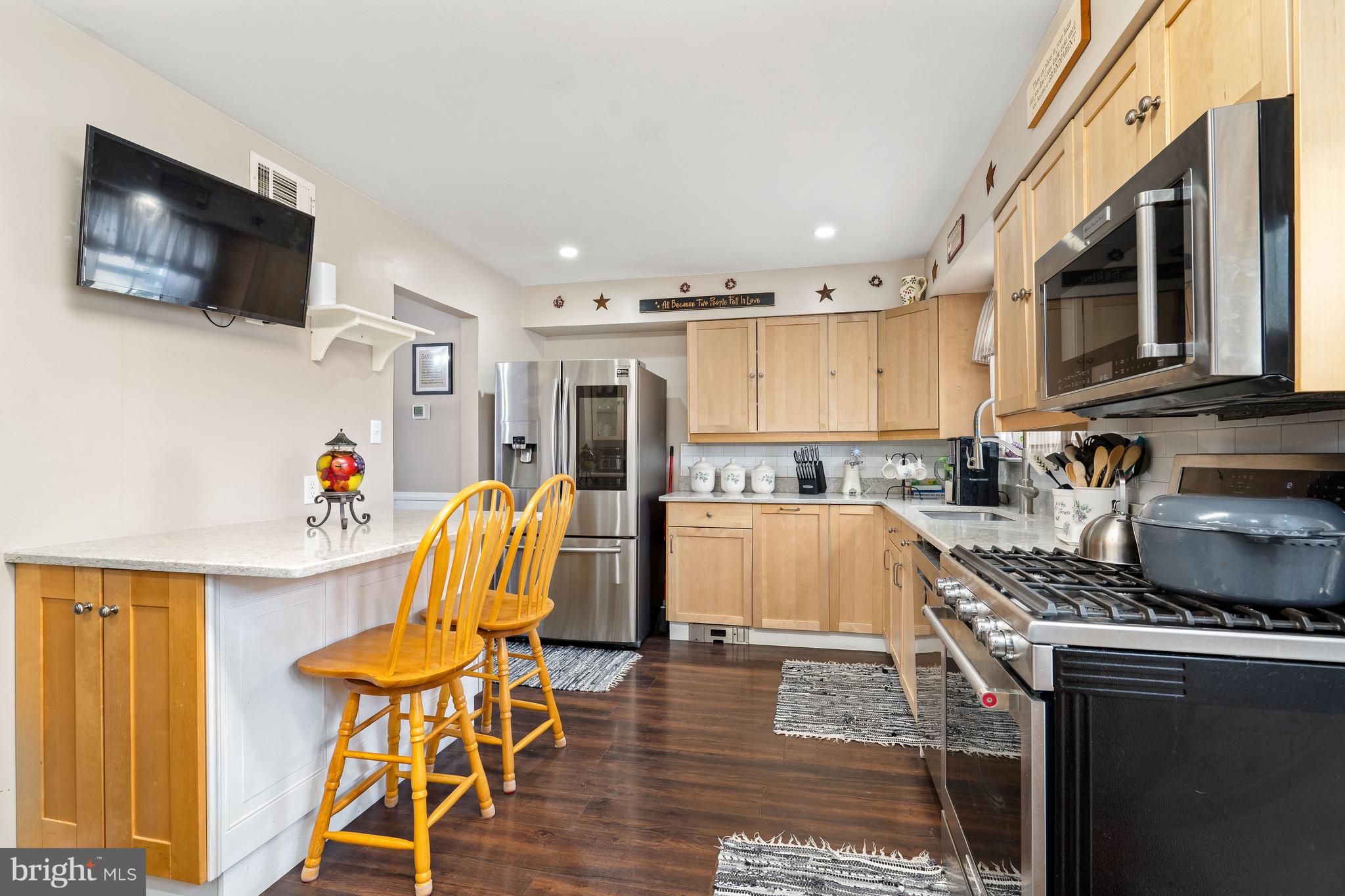 26 Southbridge Road Bear, DE 19701 - Photo 19 of 29 a kitchen with a table chairs refrigerator and a sink
