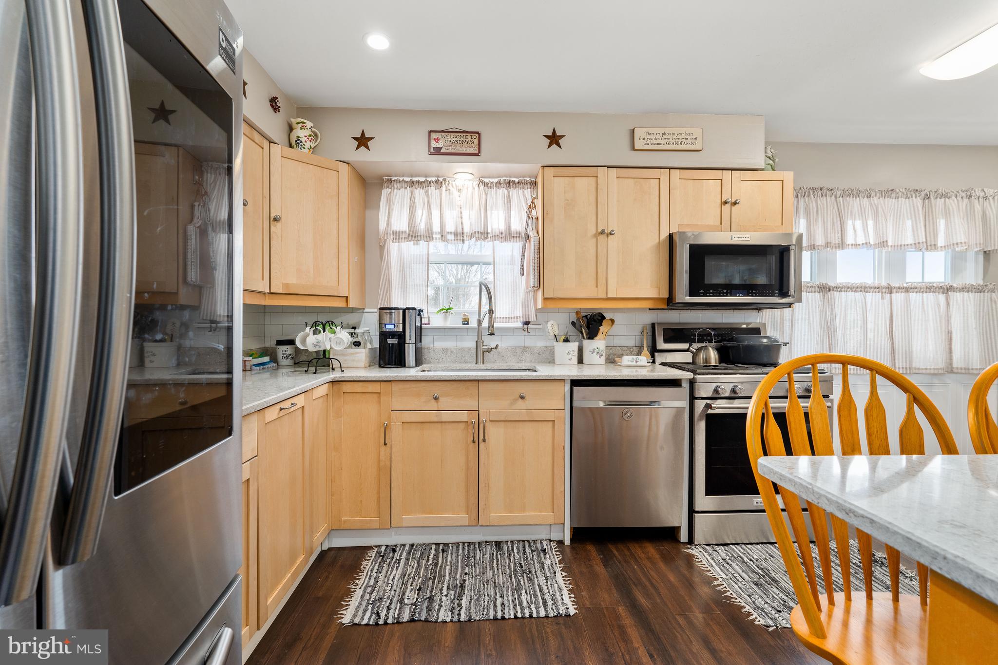 26 Southbridge Road Bear, DE 19701 - Photo 20 of 29 a kitchen with granite countertop a refrigerator a sink a stove and cabinets