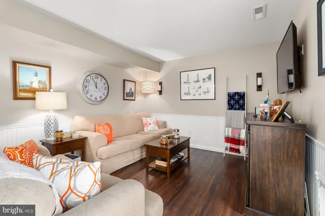 a bedroom with furniture and wooden floor
