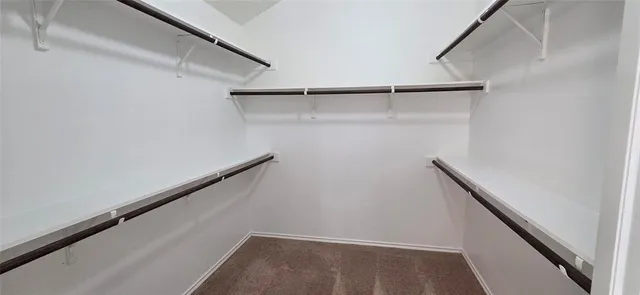 a view of backyard with wooden fence