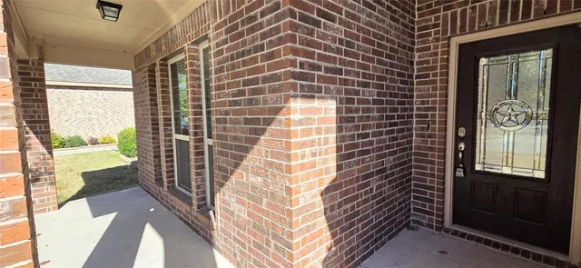 a view of a balcony with wooden floor and a potted plant