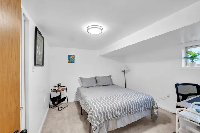 a bedroom with a bed and a desk