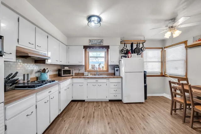a kitchen with sink cabinets and wooden floor