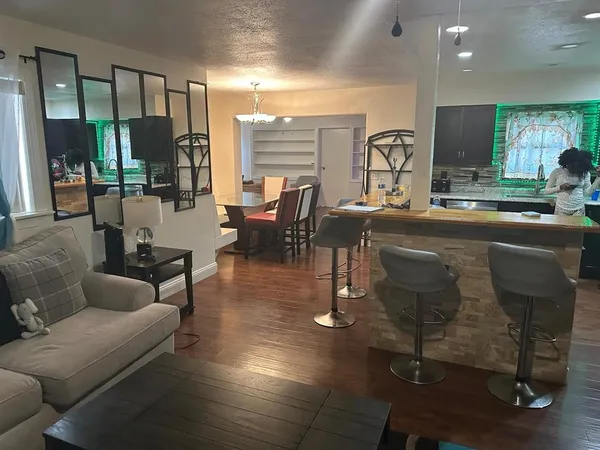 a living room with fireplace furniture and a large window
