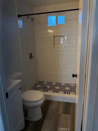 a bathroom with a toilet and a shower