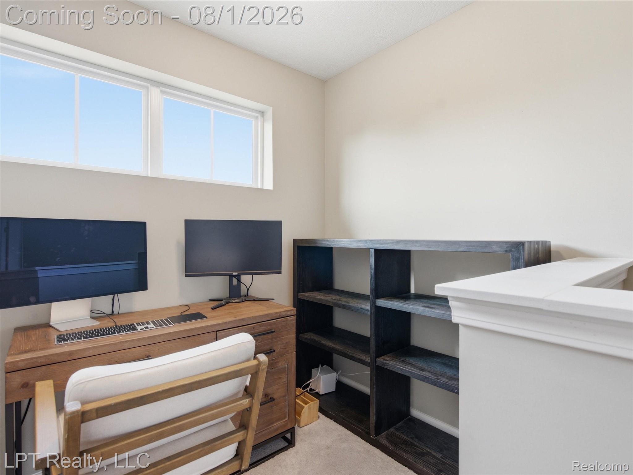 511 York Road Howell, MI 48855 - Photo 17 of 35 Dedicated office area featuring a built-in shelving unit, natural light from upper windows, and neutral wall tones