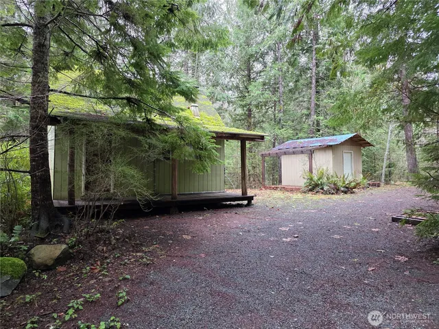 a view of a house with a yard and tree