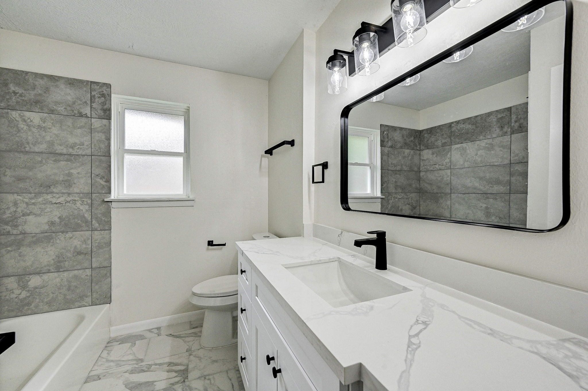 6027 Ledbetter Street Houston, TX 77087 - Photo 12 of 23 a bathroom with a sink a toilet and shower