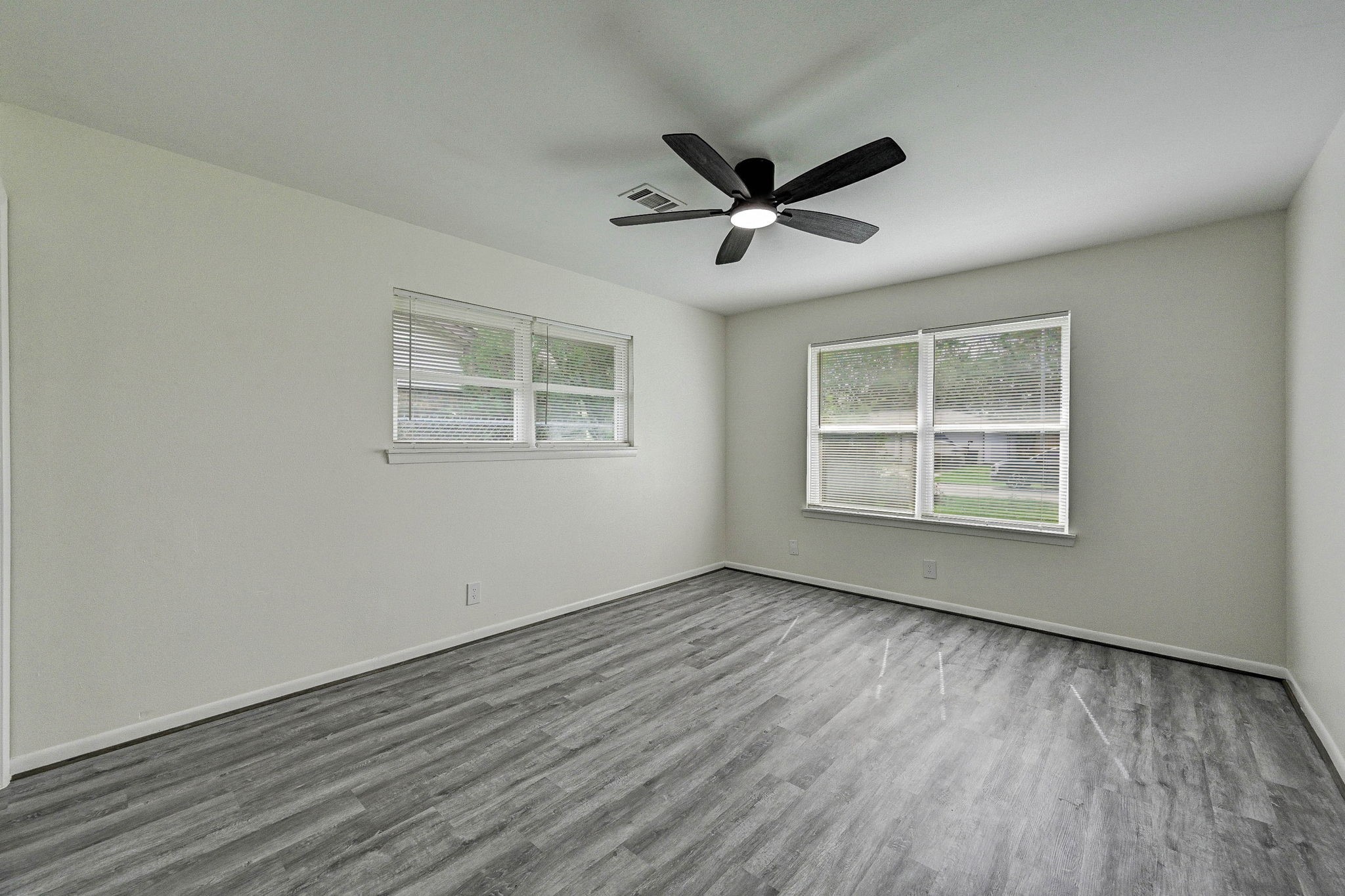 6027 Ledbetter Street Houston, TX 77087 - Photo 14 of 23 a view of an empty room with wooden floor and a window