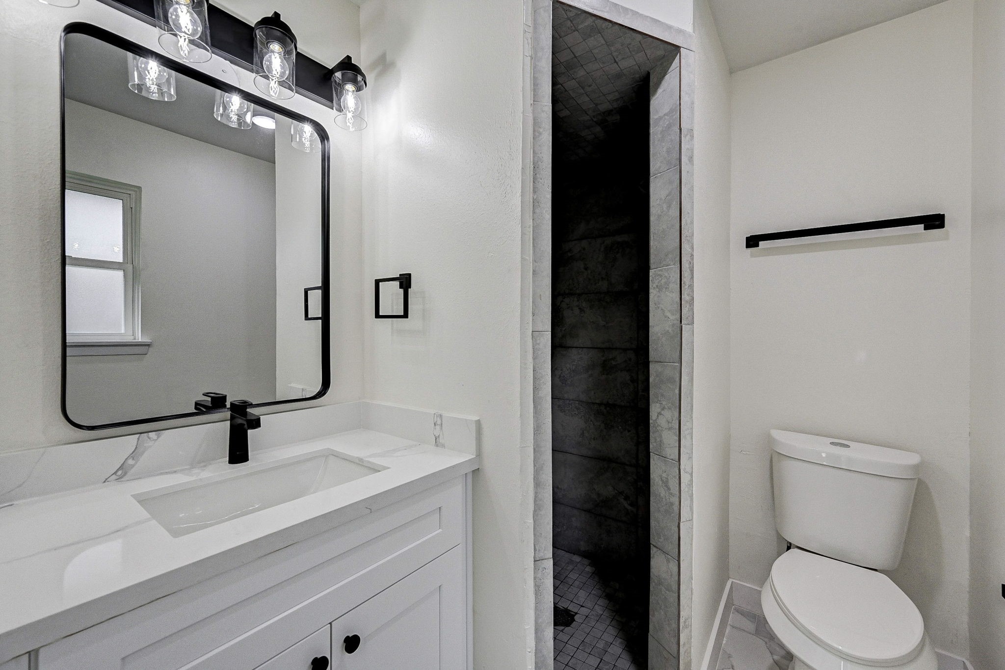6027 Ledbetter Street Houston, TX 77087 - Photo 15 of 23 a bathroom with a sink a toilet and shower
