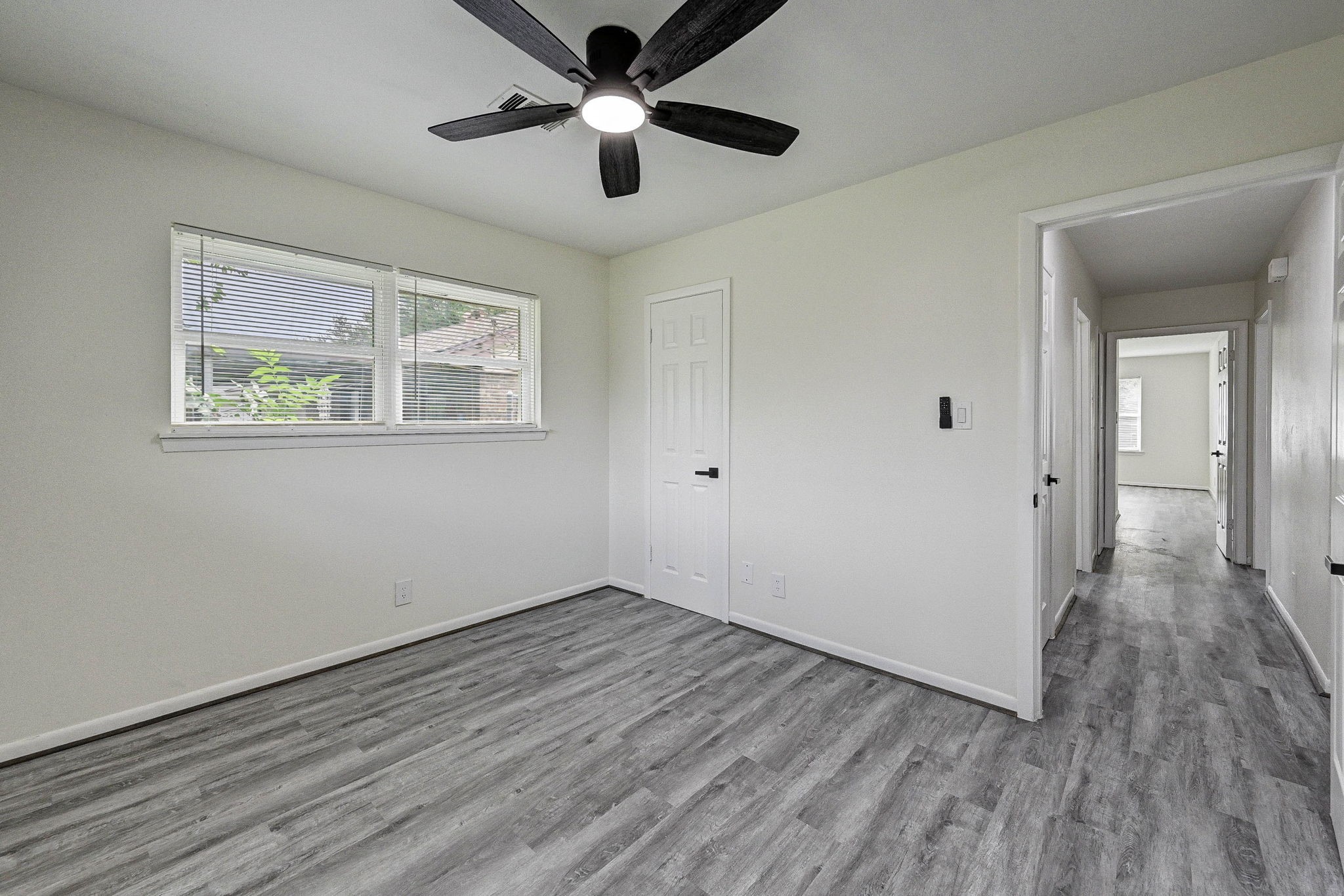 6027 Ledbetter Street Houston, TX 77087 - Photo 19 of 23 wooden floor in an empty room with a window