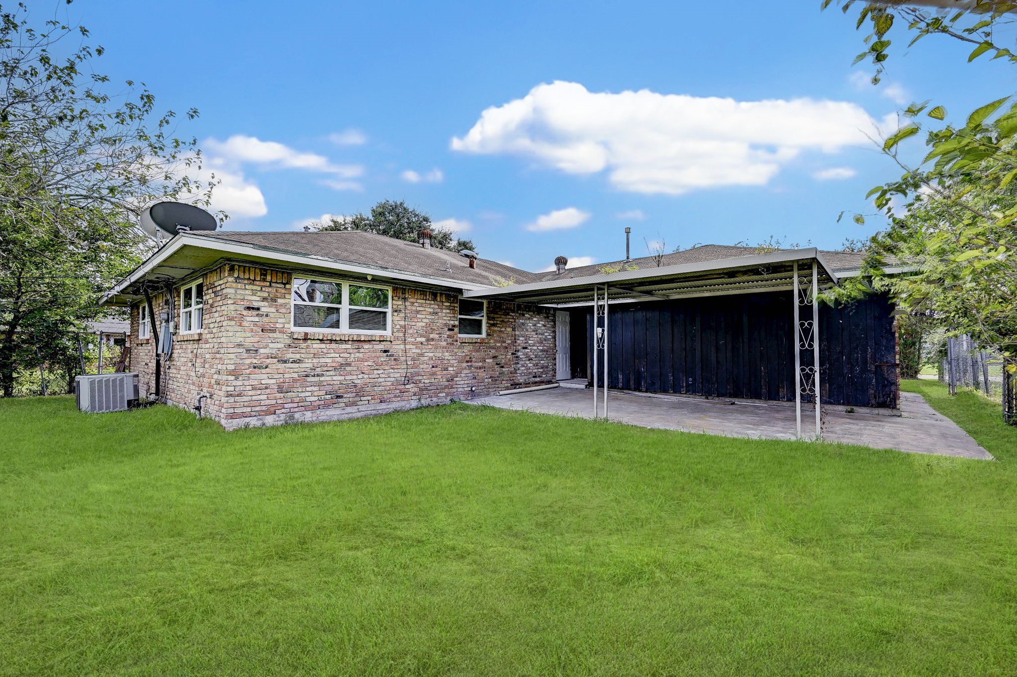 6027 Ledbetter Street Houston, TX 77087 - Photo 20 of 23 a view of a backyard with table and chairs plants and large tree