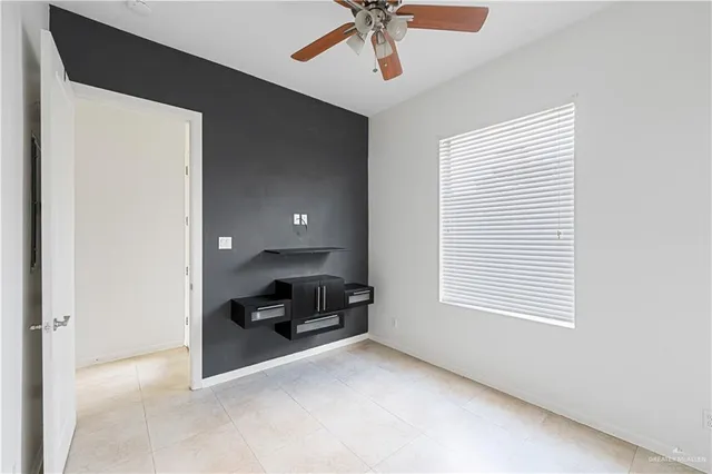 a view of a livingroom with a computer on a bookshelf