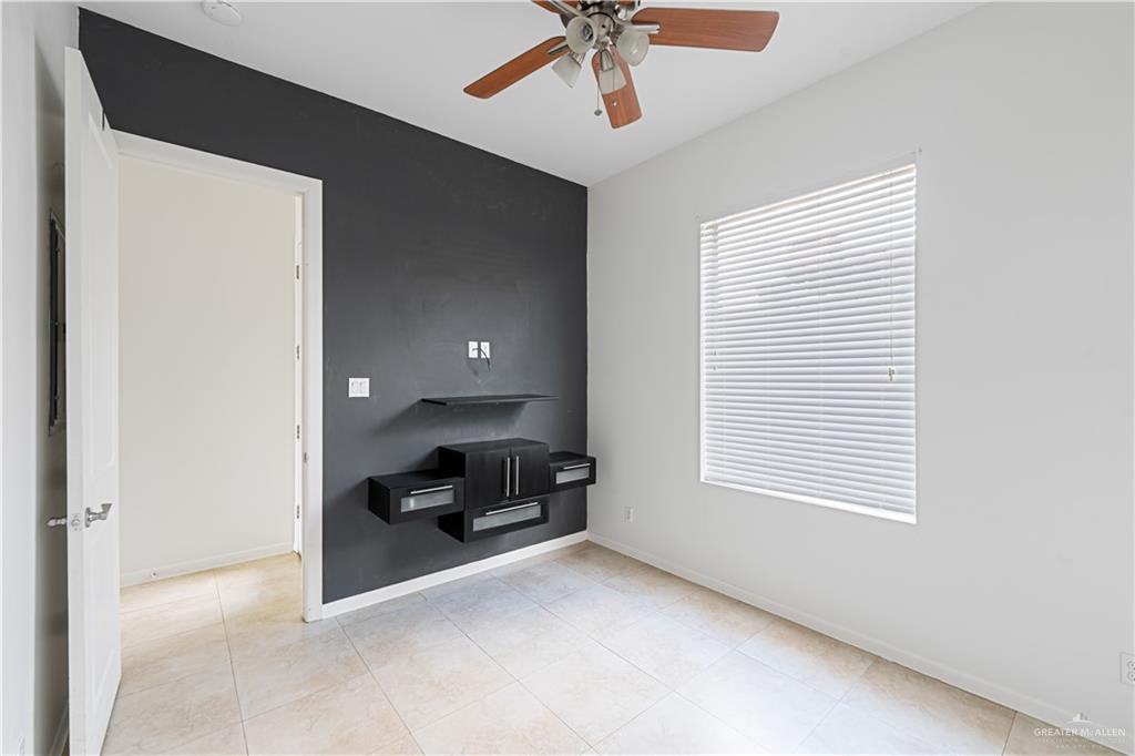 1209 Olympia Avenue, Unit 3 McAllen, TX 78503 - Photo 12 of 21 a view of a livingroom with a computer on a bookshelf