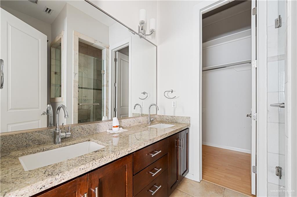 1209 Olympia Avenue, Unit 3 McAllen, TX 78503 - Photo 17 of 21 a bathroom with a granite countertop sink and a mirror