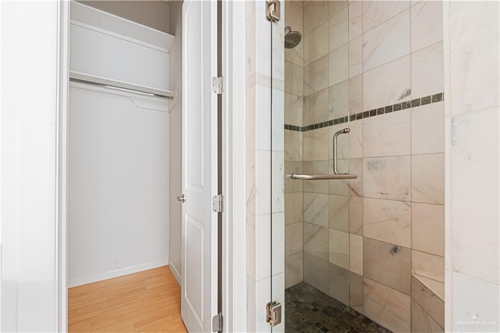 1209 Olympia Avenue, Unit 3 McAllen, TX 78503 - Photo 19 of 21 a bathroom with a glass shower door