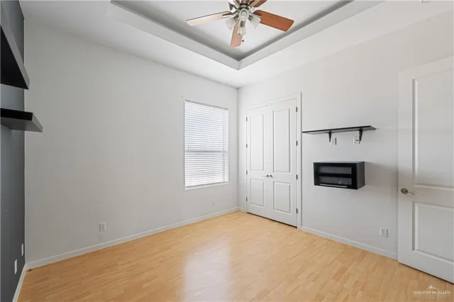 an empty room with windows and fireplace