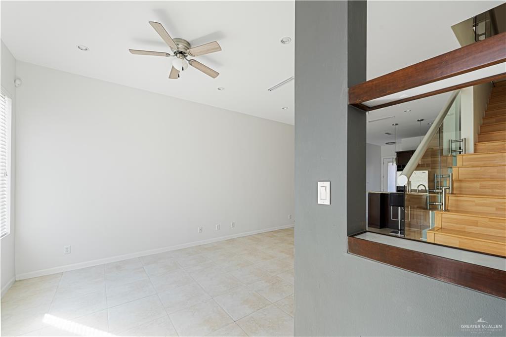 1209 Olympia Avenue, Unit 3 McAllen, TX 78503 - Photo 7 of 21 an empty room with chandelier fan and windows