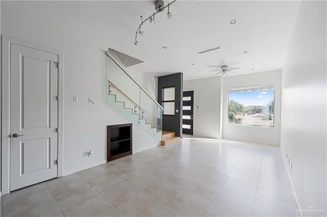 an empty room with furniture and a fireplace